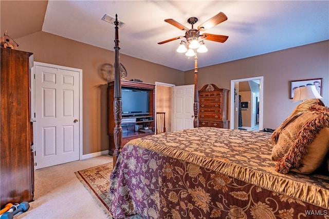 bedroom with vaulted ceiling, ceiling fan, and light colored carpet