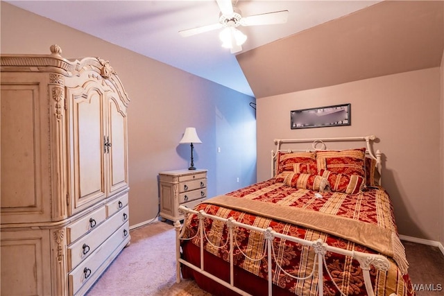 carpeted bedroom with ceiling fan and vaulted ceiling