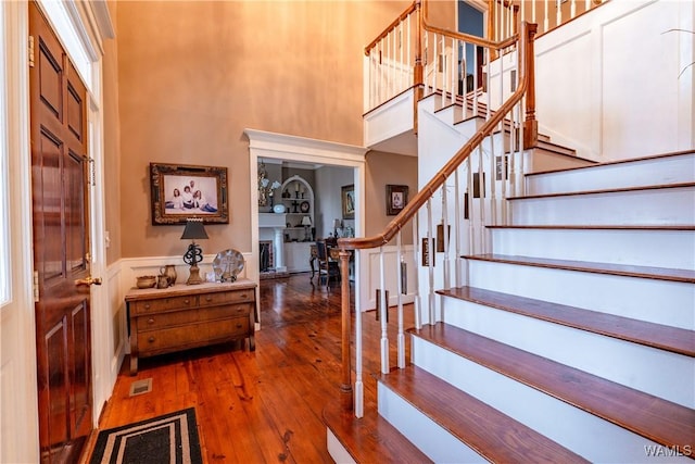 entryway with a high ceiling and hardwood / wood-style floors