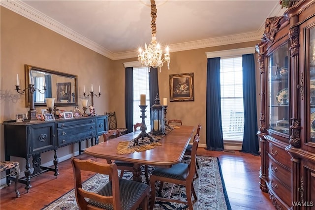 dining room featuring an inviting chandelier, a wealth of natural light, and hardwood / wood-style flooring