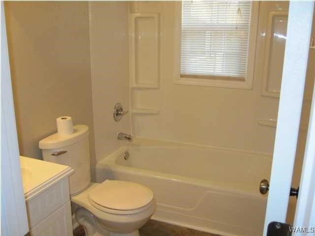 full bathroom featuring shower / bathing tub combination, vanity, and toilet