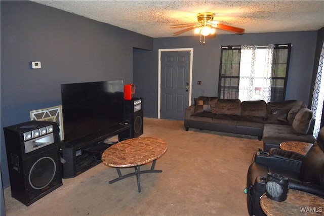 carpeted living area featuring a textured ceiling and a ceiling fan