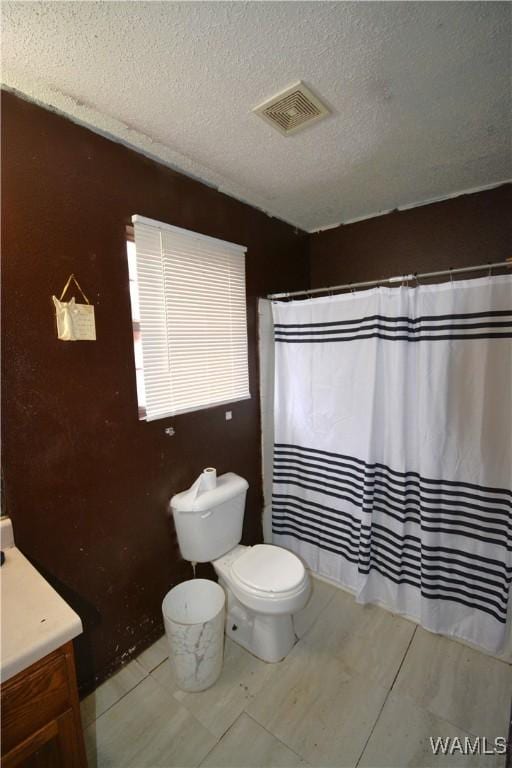 bathroom with visible vents, toilet, a shower with curtain, a textured ceiling, and vanity