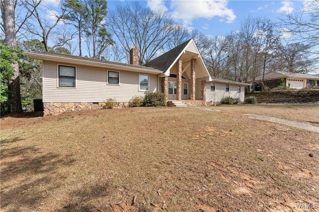 view of front facade featuring crawl space, a chimney, and a front lawn