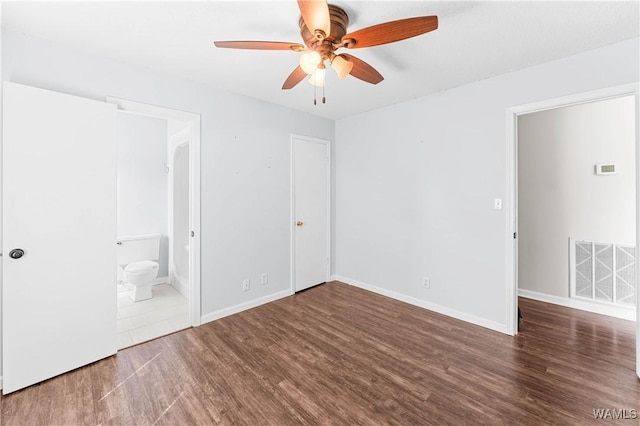 unfurnished bedroom with wood finished floors, visible vents, baseboards, ceiling fan, and ensuite bathroom