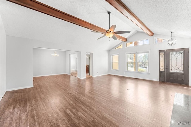 unfurnished living room featuring wood finished floors, baseboards, lofted ceiling with beams, a textured ceiling, and ceiling fan with notable chandelier