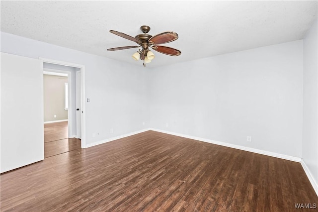 empty room featuring baseboards, a ceiling fan, and wood finished floors