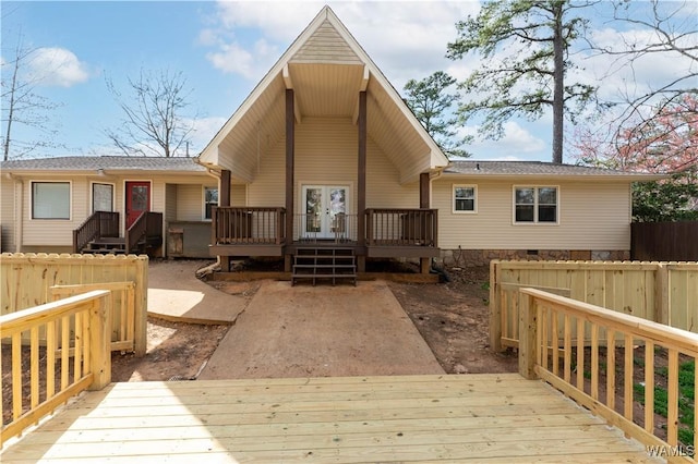 back of house with a wooden deck, fence, and french doors