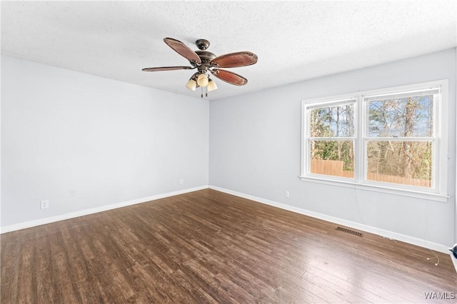 empty room with ceiling fan, baseboards, a textured ceiling, and wood finished floors