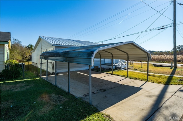 view of parking with a lawn and a carport