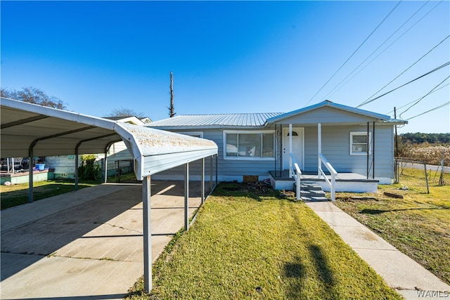 view of front of home with a carport and a front lawn