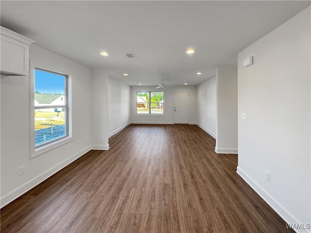 unfurnished room with ceiling fan and dark wood-type flooring