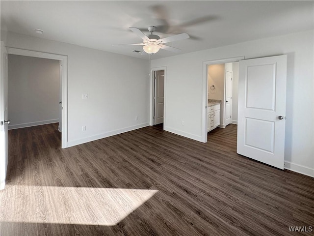 unfurnished bedroom featuring ensuite bath, ceiling fan, and dark hardwood / wood-style flooring