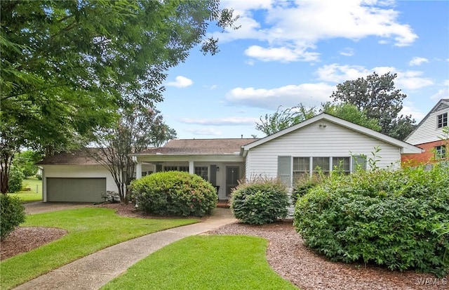 single story home featuring a front lawn and a garage