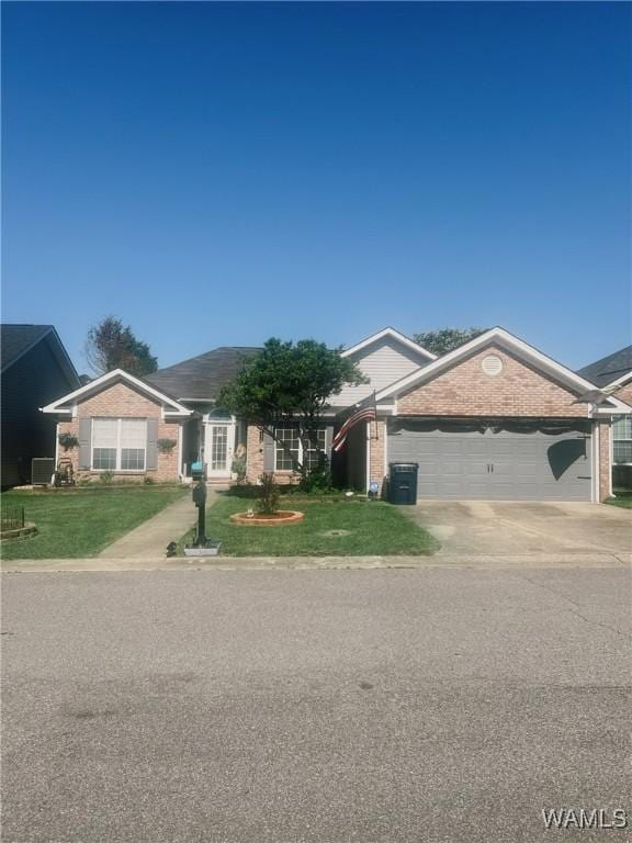 2712 Shady Bank Ln, Northport, AL 35473 - ranch-style home with a garage, brick siding, a front lawn, and concrete driveway