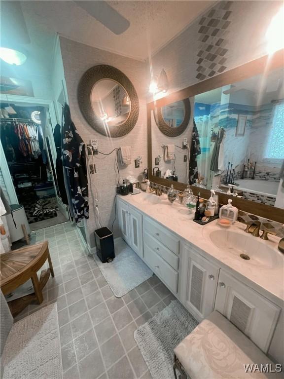 2712 Shady Bank Ln, Northport, AL 35473 - bathroom with a bath, double vanity, and a spacious closet
