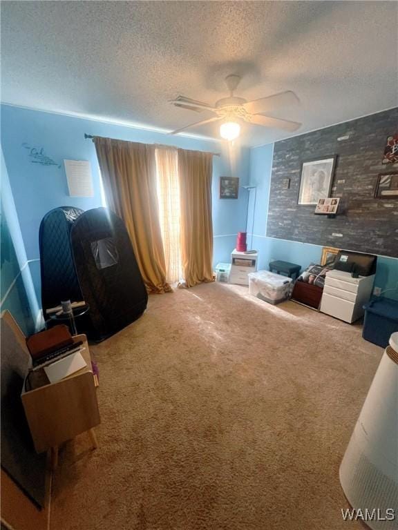 2712 Shady Bank Ln, Northport, AL 35473 - sitting room with a textured ceiling, a ceiling fan, and carpet flooring