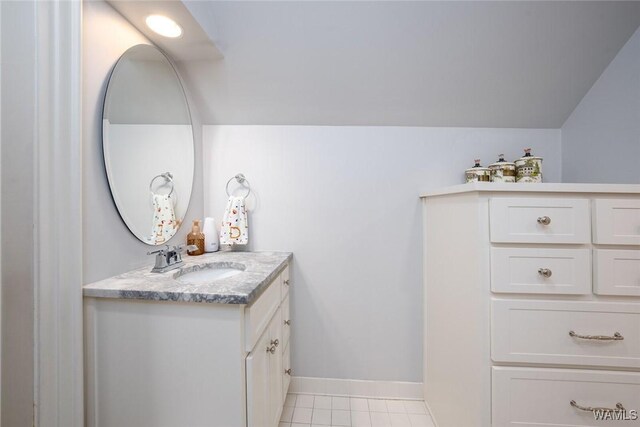 bathroom with tile patterned flooring, vanity, and tiled shower / bath combo