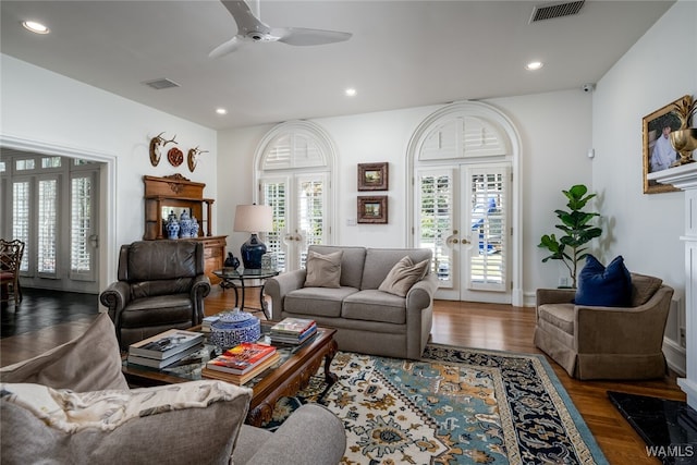 living room featuring dark hardwood / wood-style flooring, ceiling fan, and french doors