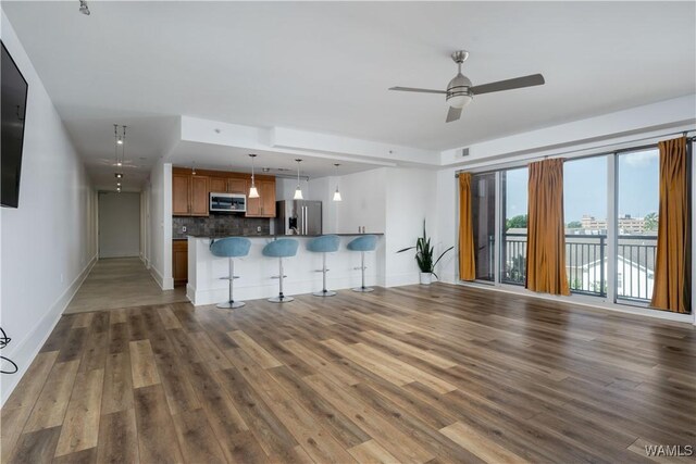 1018 Hackberry Ln Unit 301, Tuscaloosa, AL 35401 - unfurnished living room with wood finished floors and ceiling fan