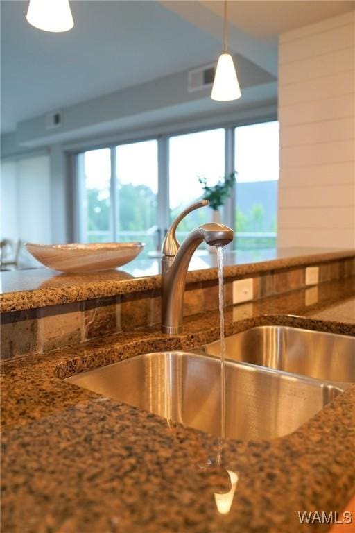 1018 Hackberry Ln Unit 113, Tuscaloosa, AL 35401 - kitchen view of hanging light fixtures and dark stone countertops