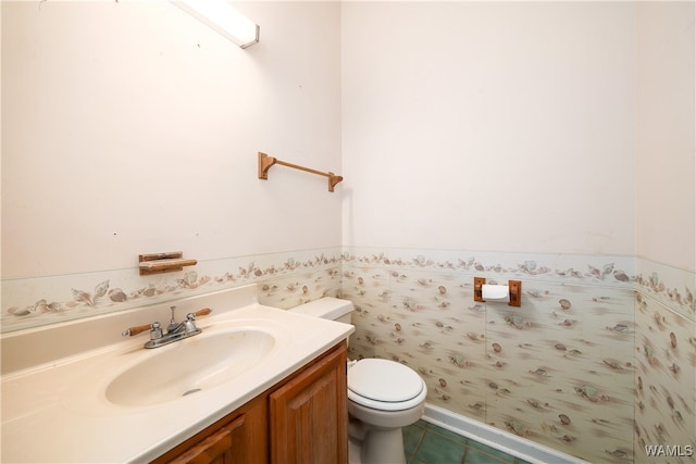 bathroom featuring tile patterned flooring, vanity, and toilet