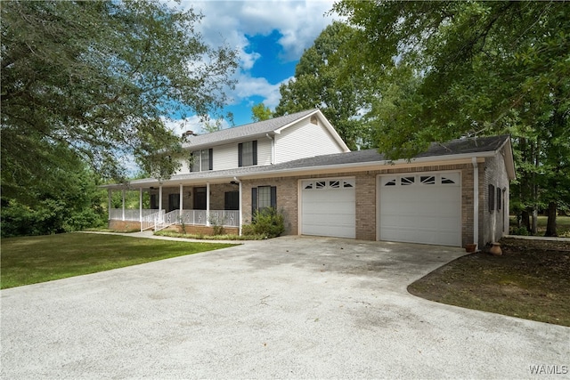 view of front facade featuring a porch, a garage, and a front lawn