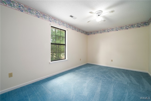 empty room featuring a textured ceiling, carpet floors, and ceiling fan