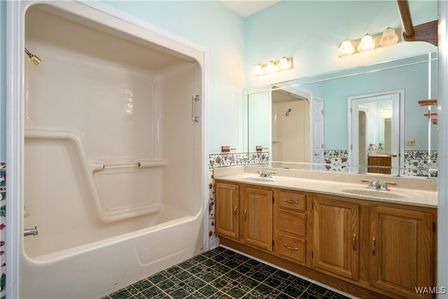 bathroom with washtub / shower combination, vanity, and tile patterned floors