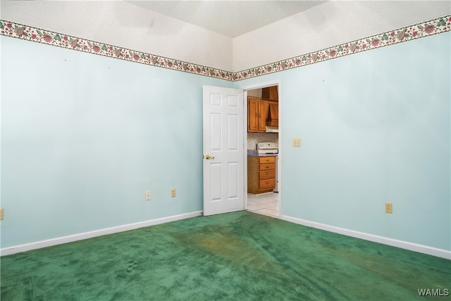 empty room featuring light colored carpet and a textured ceiling