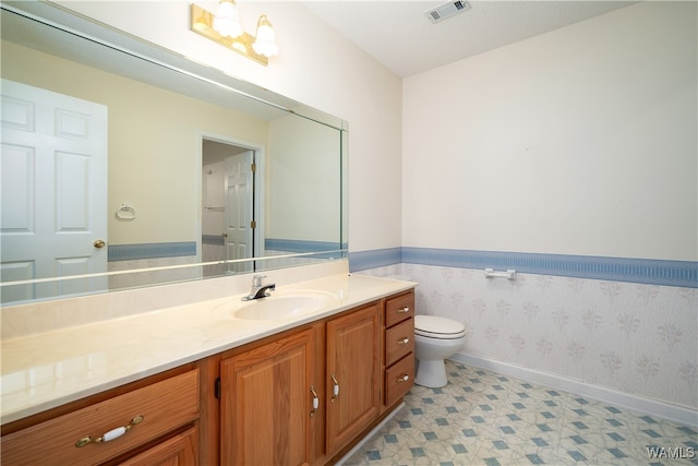 bathroom featuring vanity, a textured ceiling, and toilet