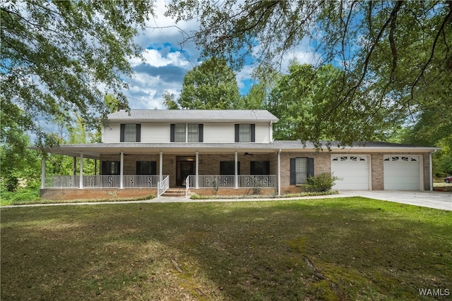 country-style home featuring a porch, a garage, and a front lawn