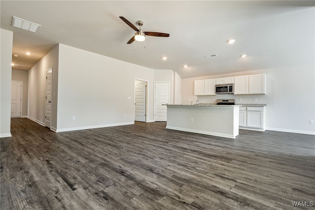 unfurnished living room with dark hardwood / wood-style floors, ceiling fan, and sink