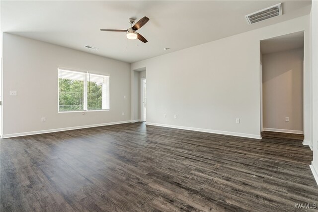 spare room featuring ceiling fan and dark hardwood / wood-style floors