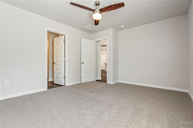 unfurnished bedroom with dark colored carpet and ceiling fan