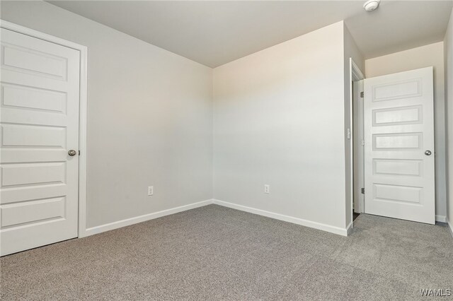 unfurnished room featuring carpet flooring