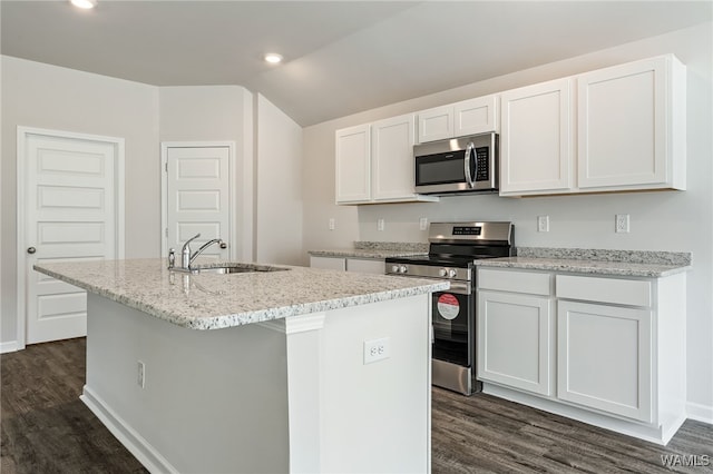 kitchen with appliances with stainless steel finishes, a center island with sink, white cabinetry, and dark wood-type flooring