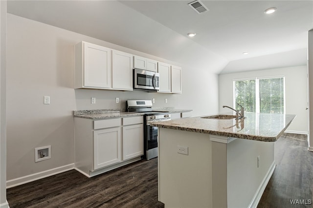 kitchen featuring appliances with stainless steel finishes, a center island with sink, white cabinetry, and sink