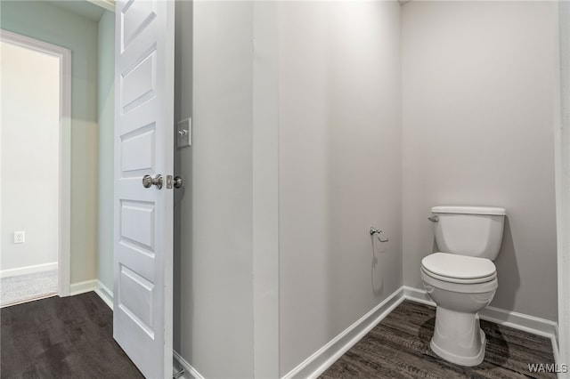 bathroom featuring hardwood / wood-style flooring and toilet