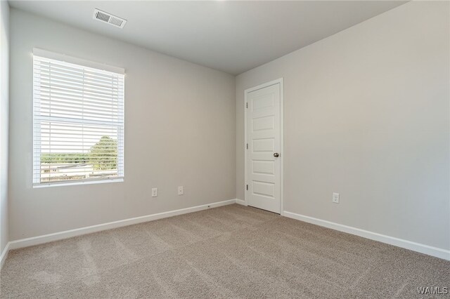 spare room with light colored carpet