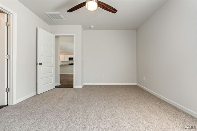 unfurnished bedroom featuring ceiling fan and carpet