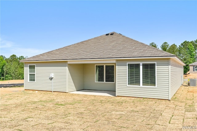 back of property featuring a lawn, a patio area, and central AC unit