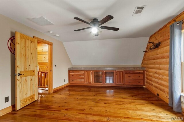 20442 Old Jasper Rd, Northport, AL 35475 - additional living space with vaulted ceiling, log walls, visible vents, and light wood-type flooring