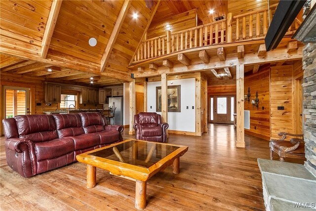 20442 Old Jasper Rd, Northport, AL 35475 - living area featuring light wood finished floors, wood walls, wooden ceiling, and a healthy amount of sunlight
