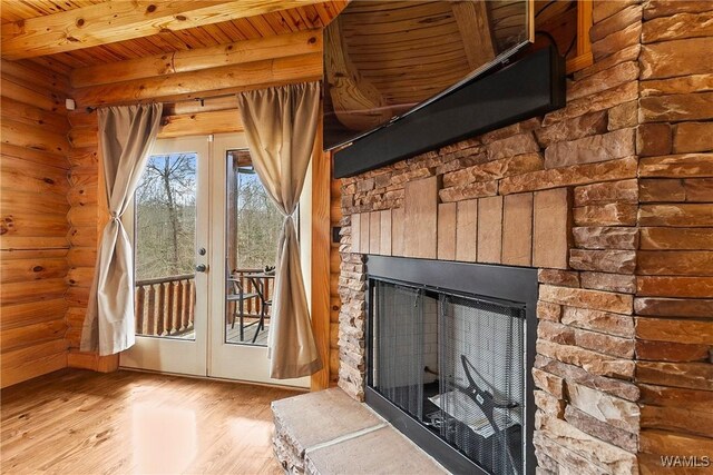 20442 Old Jasper Rd, Northport, AL 35475 - doorway to outside with wood finished floors, a fireplace, wooden ceiling, beamed ceiling, and rustic walls
