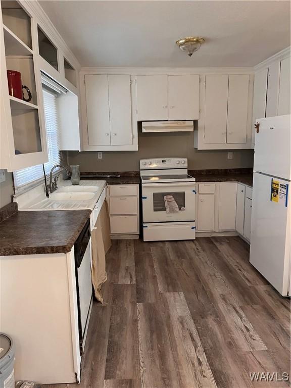 kitchen with white cabinetry, dark wood-type flooring, sink, and white appliances