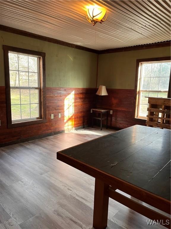 interior space featuring hardwood / wood-style floors, a wealth of natural light, wooden ceiling, and wooden walls