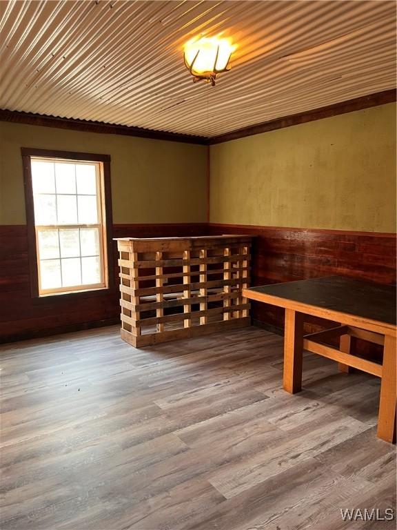 interior space featuring hardwood / wood-style floors and wooden walls