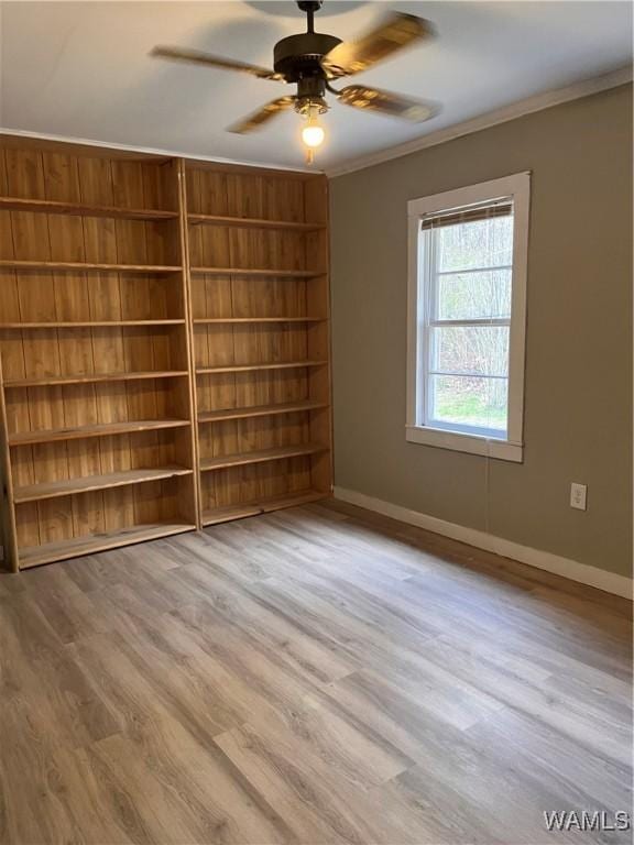 unfurnished room with crown molding, ceiling fan, and light hardwood / wood-style flooring