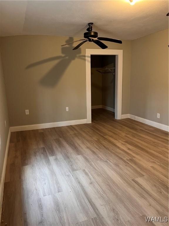 unfurnished bedroom featuring hardwood / wood-style flooring and a closet